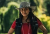 A woman in a hat looking at the camera.