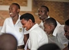 Group of people in white shirts laughing