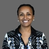 Mefthe Tadesse wearing a striking patterned shirt and smiling