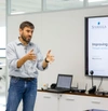Man standing infront of laptop adressing room