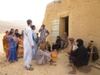 A group of people congregate around a door way