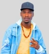 Oumar Ndao in a light blue denim jacket with a yellow shirt and a black baseball cap