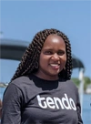 Primerose Katena smiling into camera in a Tendo t-shirt