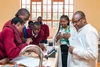 Group of students gathered working together with two teachers