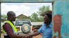 Vasco Hamisi shaking hands with an electricity client, Kakuma refugee camp, 2025.