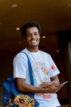 A young man smiling at Scholars @10