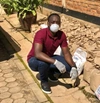 Man crouched down wearing a facemark 