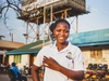 Lucy Aciro standing outdoors and smiling