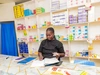 Victoria, doing some paperwork behind the counter at her healthcare clinic, in Gurei, South Sudan 2026.
