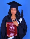 Roza Abrham in cap and gown holding her class of 2024 University of Gondor diploma