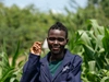 Selphine Akiru standing outside in dark blue coveralls