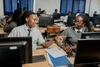 Tow young women in a classroom full of computers at the Gashora Girls Academy Science and Technology 2024