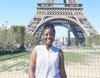 Miriam Odonkor stood smiling to camera in front of the Eiffel Tower