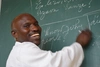  Man smiling to camera writing on a blackboard