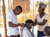 William braiding hair with his colleague