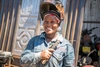 Mariam Sulaiman smiling and wearing her protective welding gear, in Kakuma refugee camp, Kenya, 2026