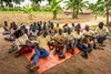 Gordon Victor sitting outside with a group of people learning about farming