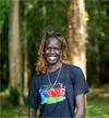 Apat Bul Kiir Aguer at EARTH U in Costa Rica, smiling outdoors 