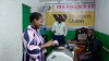 Four people counting money inside a financial institution, supported by YIDA Youth Initiative, Kyaka II Refugee Settlement, Uganda 2026