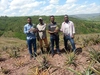 Kevin Ganza and Lawali Franck in one of the ISOKOFARMS partners’ pineapple plantations in Rwanda stood together outdoors