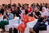 A group pf people, including Reeta Roy, applauding in an auditorium for the Baobab summit 2022