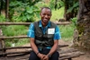 Nelson Kolliesuah  sitting outdoors in a vest in Liberia