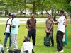 A group of participants from the North American Alumni Network socializing together at a park during their summer social in 2025.