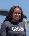 Primerose Katena smiling into camera in a Tendo t-shirt