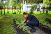 Melissa working on her plants outdoors