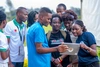 Mastercard Foundation Scholars in a group looking at a tablet together