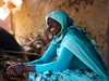 Sekina Hassen, smiling at her bakery shop, wearing a striking teal shirt and head covering, supported by partner Inkomoko 2026