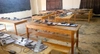 Several wooden desks and computer equipment on top