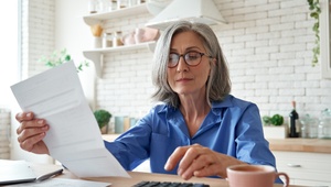 woman on calculator looking at a bill