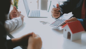 couple at bank looking at calculator