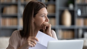 worried woman holding letter
