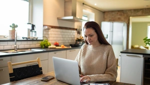 Woman on her laptop in the kitchen