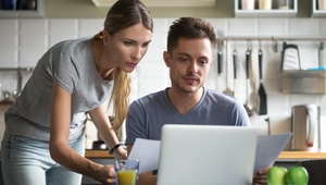 couple on laptop in kitchen