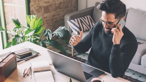 man on mobile at desk