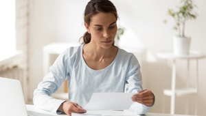 woman looking at bills