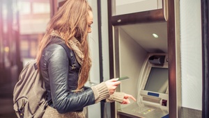 woman withdrawing cash from machine