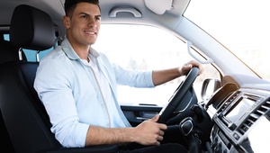 Man looking happy driving a car