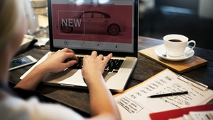 woman on laptop researching new cars