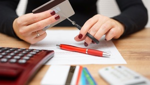 woman cutting credit card