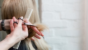 woman getting hair cut at hairdressers