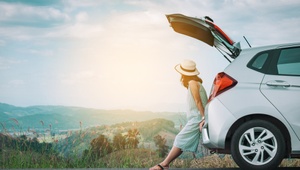woman leaning on car boot