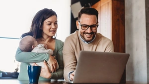Couple at computer with baby applying for a loan