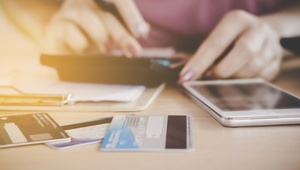 woman with calculator and credit cards