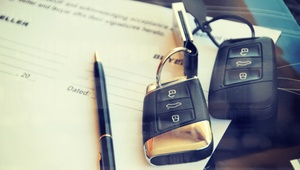 two sets of car keys and a contract