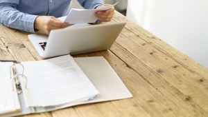 man at desk looking at paperwork