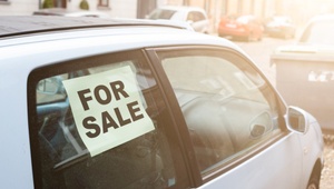 car with for sale sign in the window